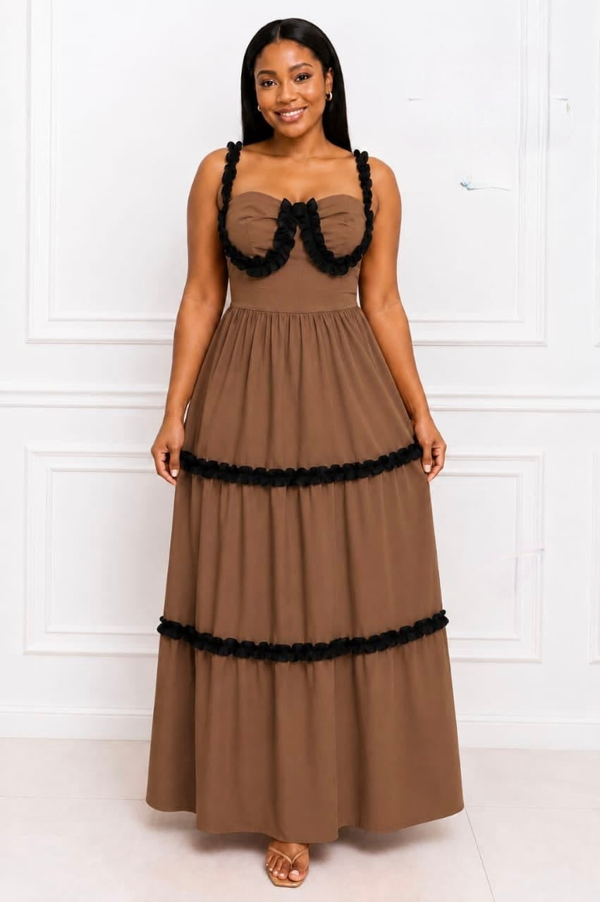 Structured bodice with ruffle detailing and tiered skirt in a flowing silhouette, perfect for formal occasions.