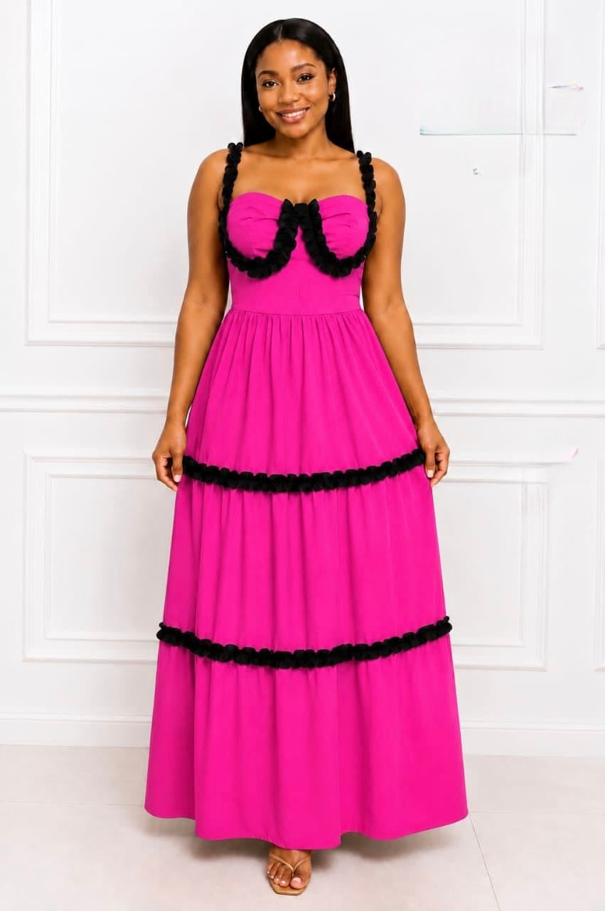 Vibrant pink Tiered Ruffle Maxi Dress with black ruffle detailing, structured bodice, sweetheart neckline, and flowing tiered skirt.