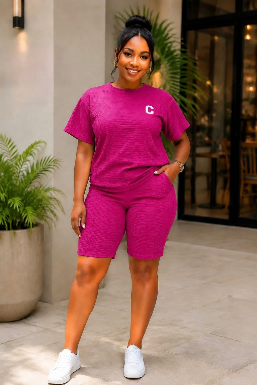 Coordinated short-sleeve top and biker shorts set in solid color, featuring a relaxed fit and minimalist chest emblem.