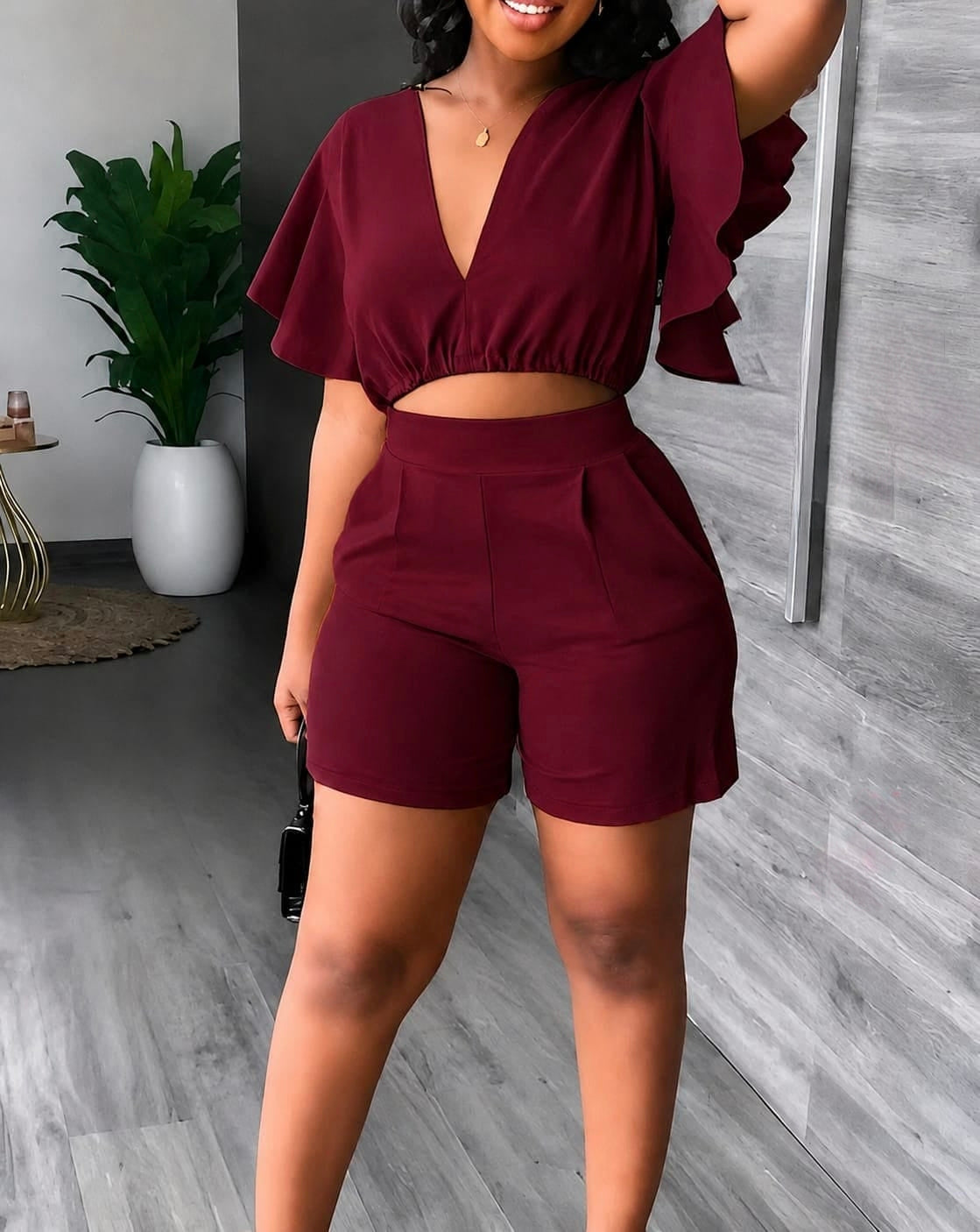 Deep burgundy Flutter Sleeve Crop & High-Waist Shorts Set styled in a casual indoor setting with plants.