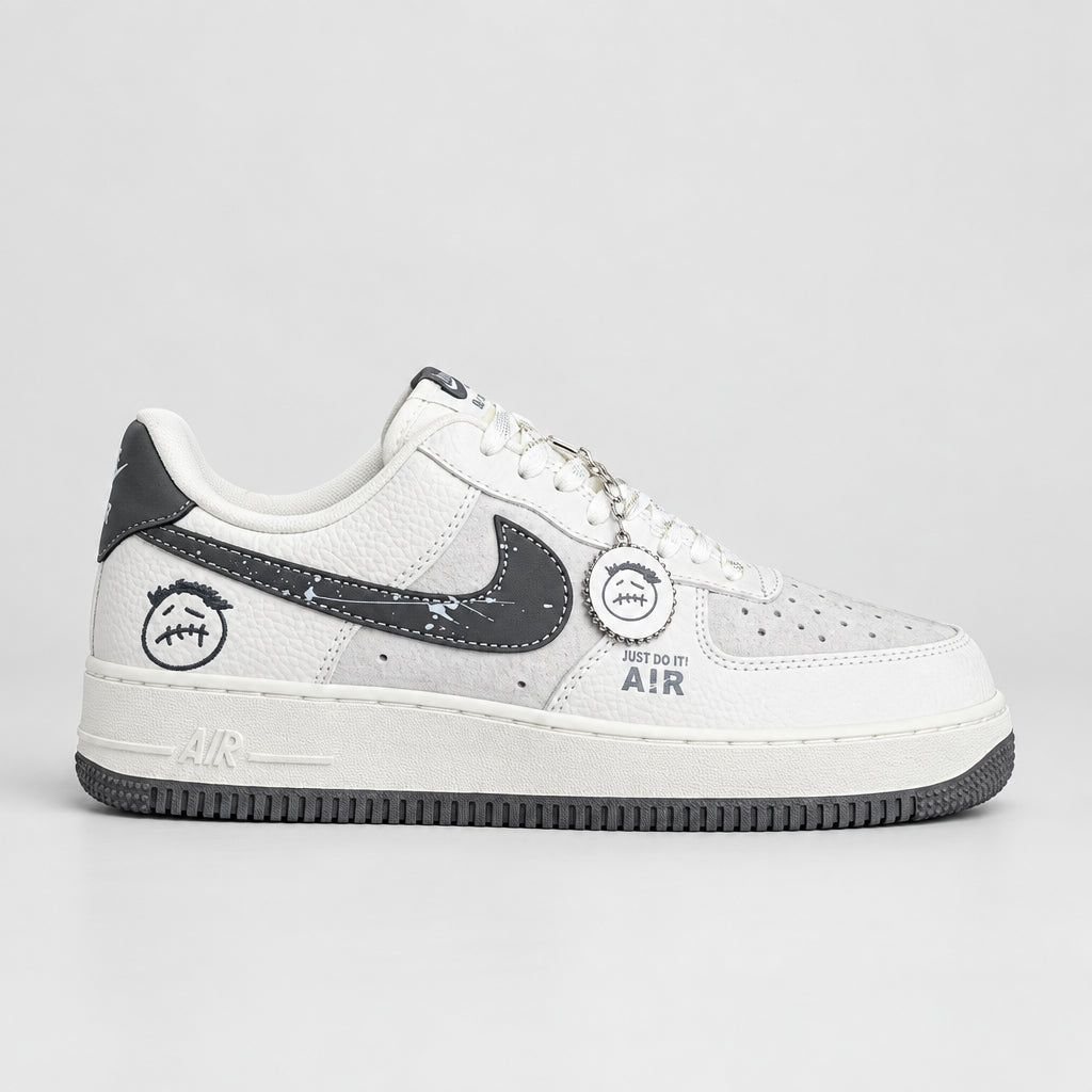 White and grey Nike Air Force 1 Low with charcoal Swoosh, smiley graphics and bottle-cap keychain | Ovadue
