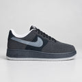 Nike Air Force 1 Low black suede and nubuck sneakers with slate-blue Swoosh, black midsole and translucent icy white-grey outsole.
