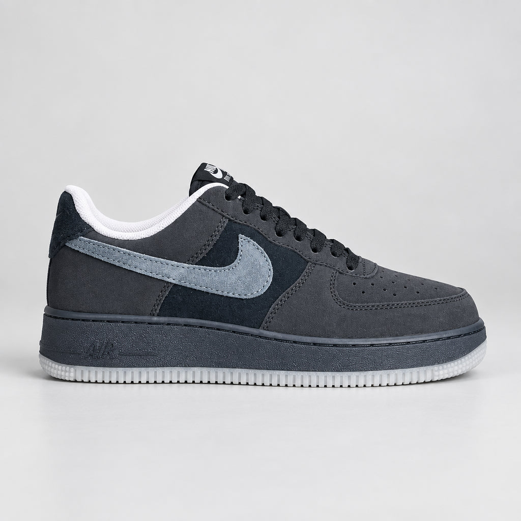 Nike Air Force 1 Low black suede and nubuck sneakers with slate-blue Swoosh, black midsole and translucent icy white-grey outsole.