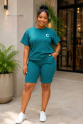 Coordinated short-sleeve top and biker shorts set in textured fabric, featuring a relaxed fit and minimalist chest emblem.