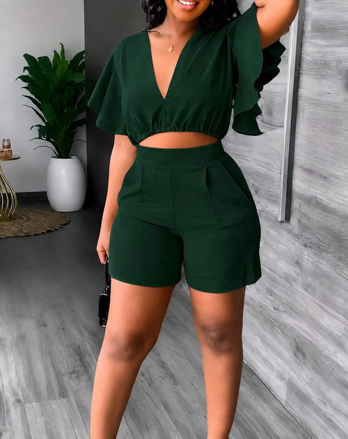 Dark green two-piece set featuring a crop top with flutter sleeves and high-waisted tailored shorts with front pleats.