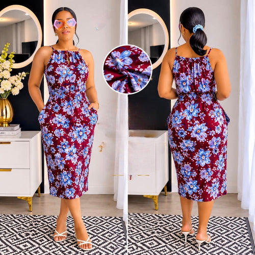 Floral print dress with blue and white flowers on burgundy, halter neck, spaghetti straps, elasticated waist, mid-calf length, pockets.