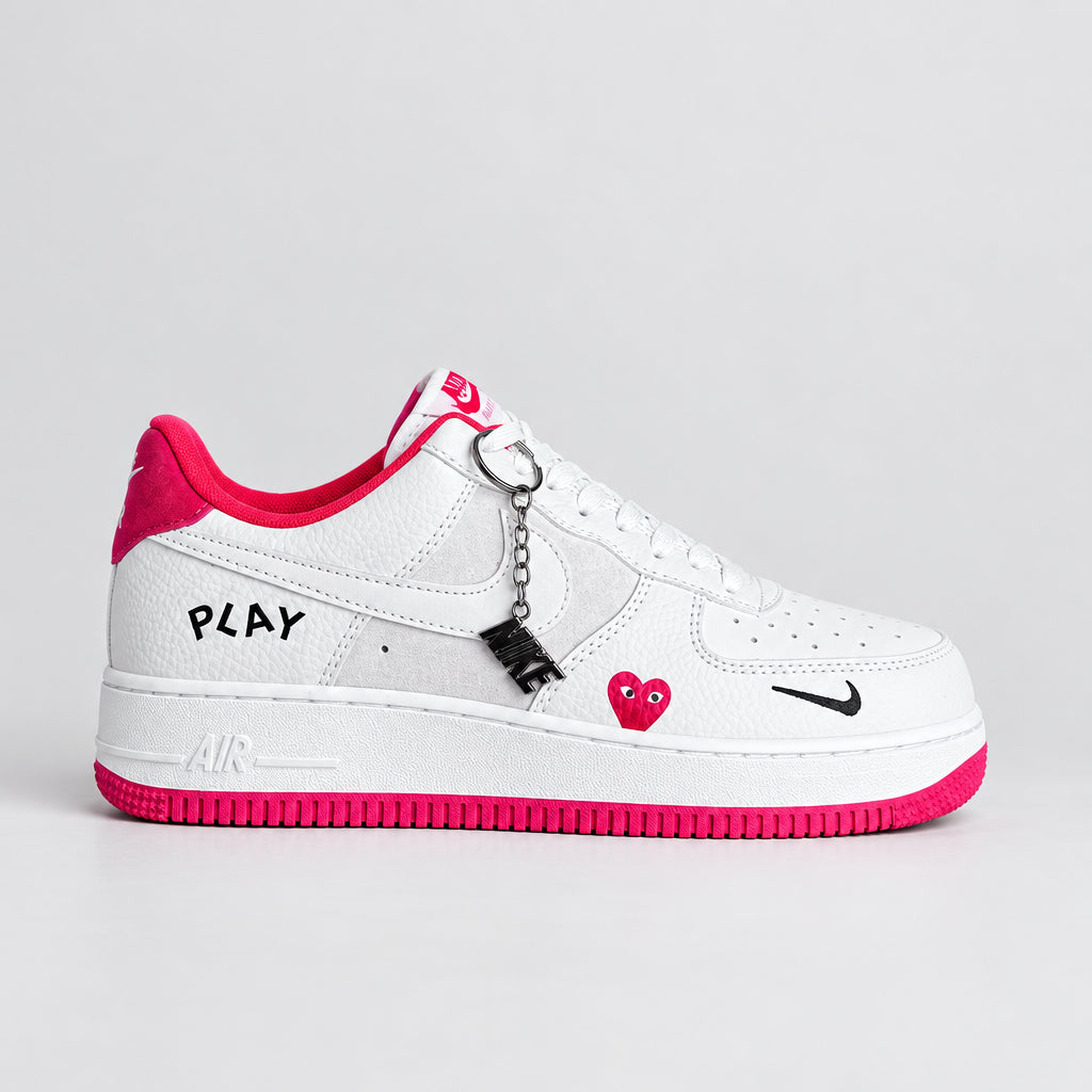 Nike Air Force 1 Low White Hot Pink PLAY sneakers with pebbled leather, grey suede, pink heart detail and black Nike charm | Ovadue