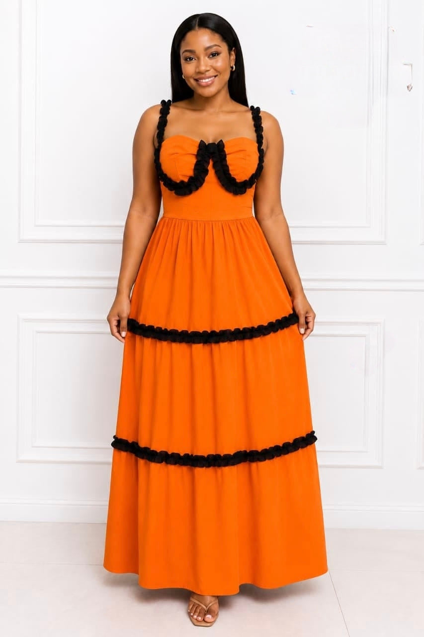 Vibrant orange tiered ruffle maxi dress with black detailing and structured bodice, showcased on a model.