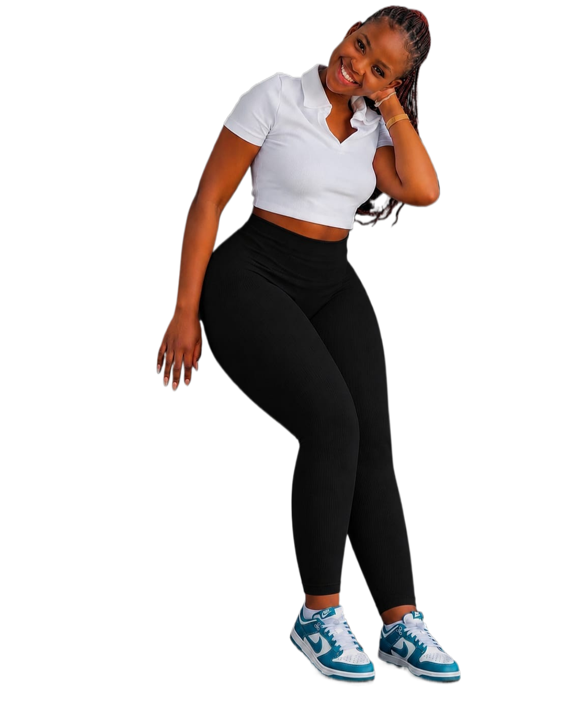 Person wearing black stretch pants with a high waist, paired with a white cropped shirt and blue sneakers.
