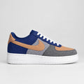 Nike Air Force 1 Low-inspired navy and camel patchwork sneakers with corduroy swoosh, grey denim-style panels and black-and-white houndstooth accents.