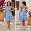 Floral print midi dress in blue and white with a square neckline and adjustable tie straps, featuring a fitted bodice and flowy skirt.